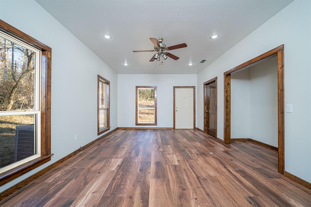 410 Private Road Leesburg, TX 75451 - Photo 5 of 38 a view of empty room with wooden floor and fan