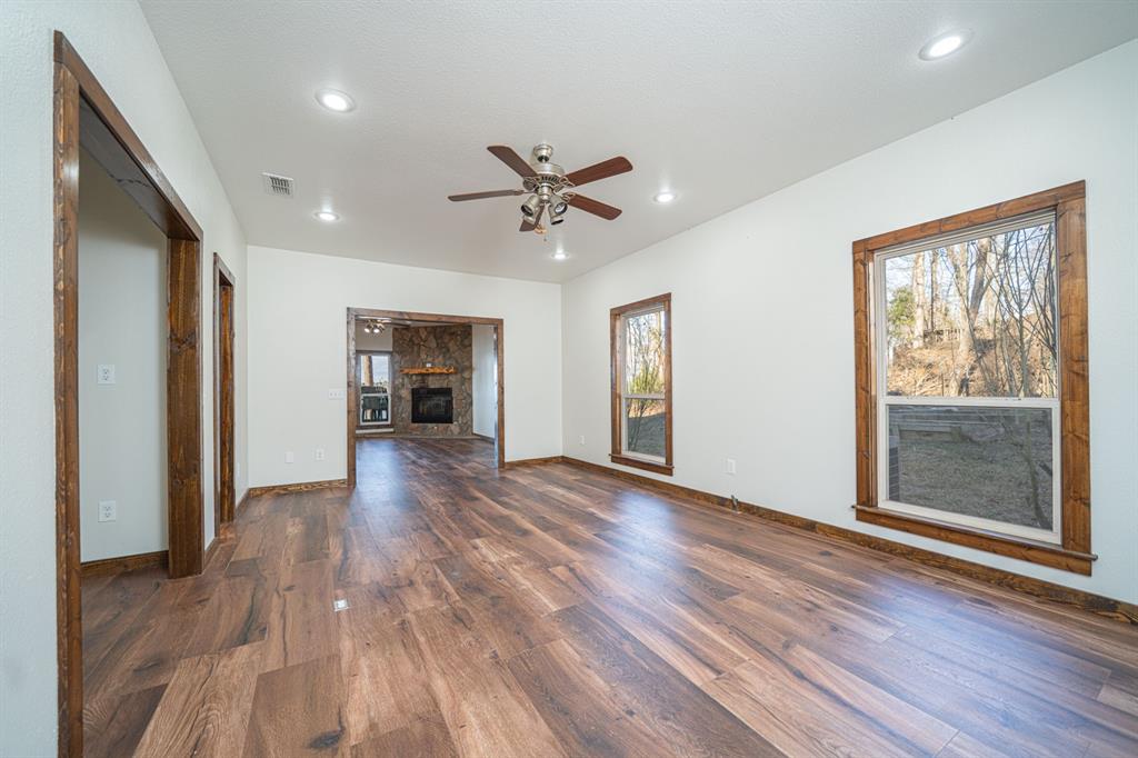 410 Private Road Leesburg, TX 75451 - Photo 6 of 38 a view of an empty room with a window and wooden floor