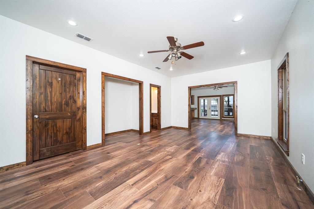 410 Private Road Leesburg, TX 75451 - Photo 7 of 38 a view of empty room with wooden floor and fan