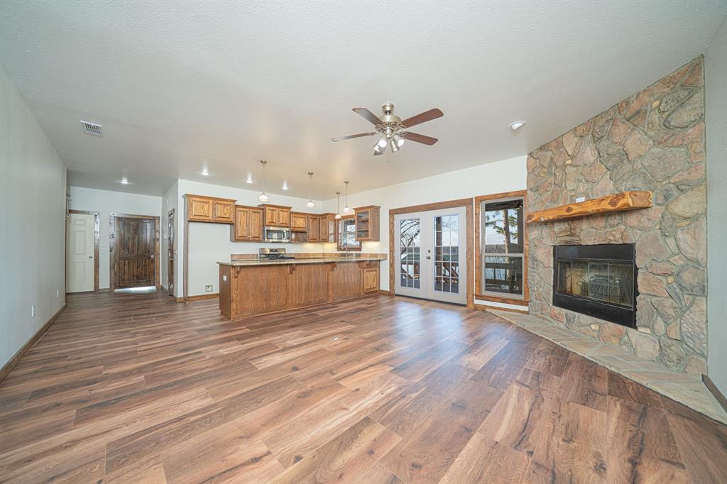 410 Private Road Leesburg, TX 75451 - Photo 8 of 38 a view of a kitchen with a stove cabinets and wooden floor