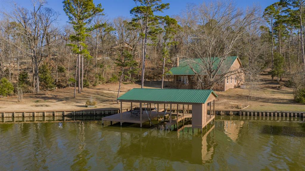 410 Private Road Leesburg, TX 75451 - Photo 10 of 38 a view of swimming pool with outdoor seating and lake