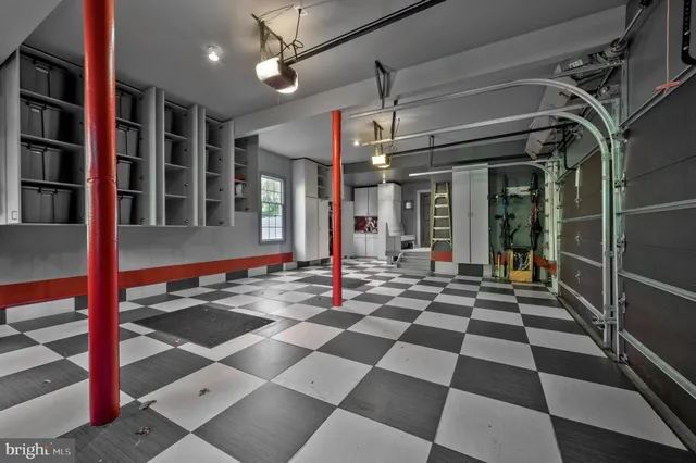 a spacious bedroom with a bed and glass windows