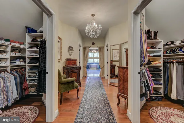a spacious bedroom with a bed a television and dresser
