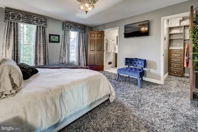 a room with lots of wooden furniture and windows