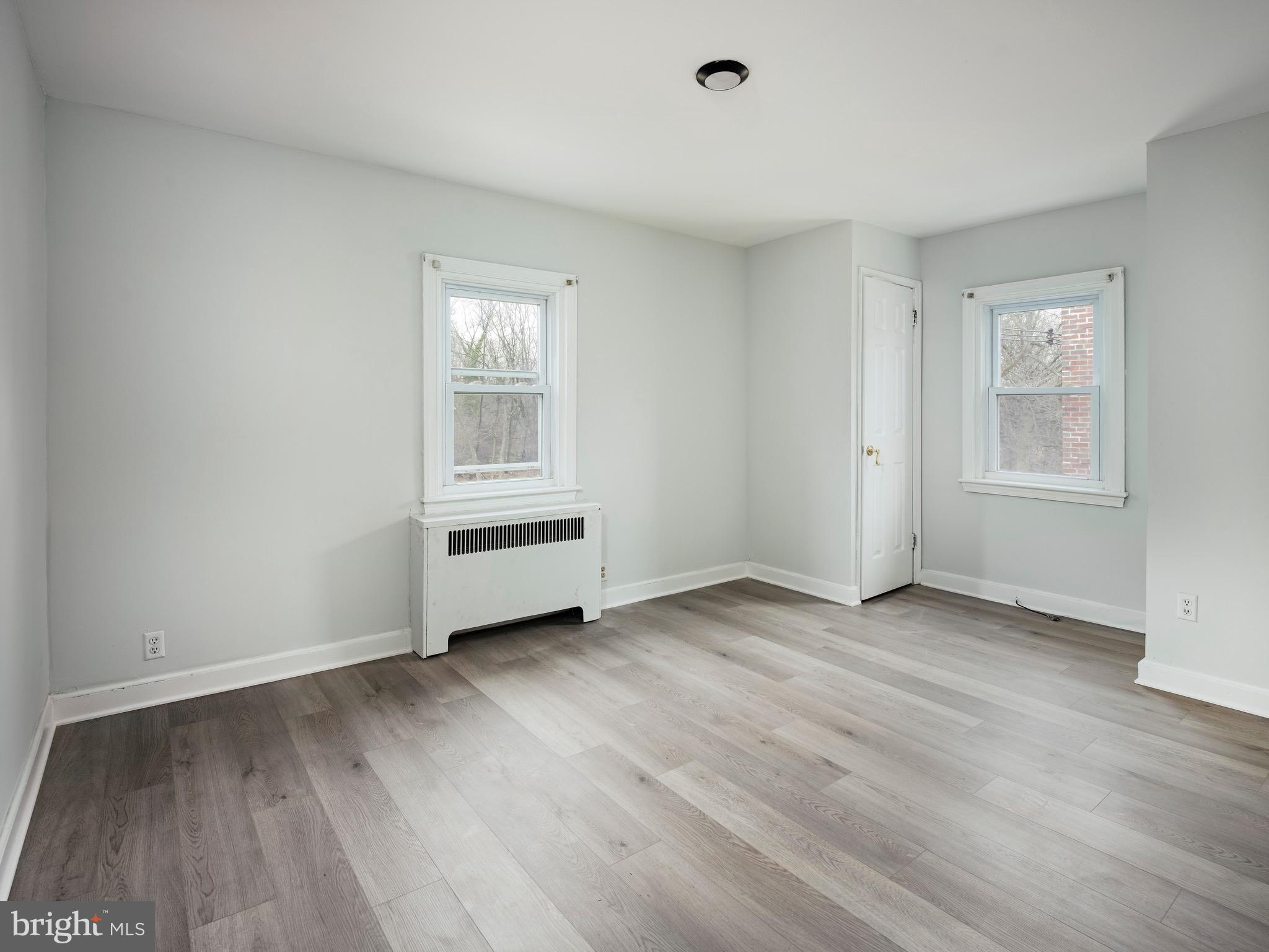 1200 Angora Avenue Lansdowne, PA 19050 - Photo 12 of 20 an empty room with wooden floor and windows
