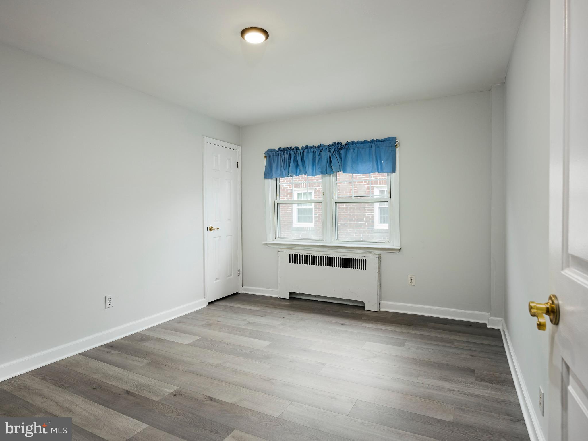 1200 Angora Avenue Lansdowne, PA 19050 - Photo 13 of 20 an empty room with wooden floor and windows