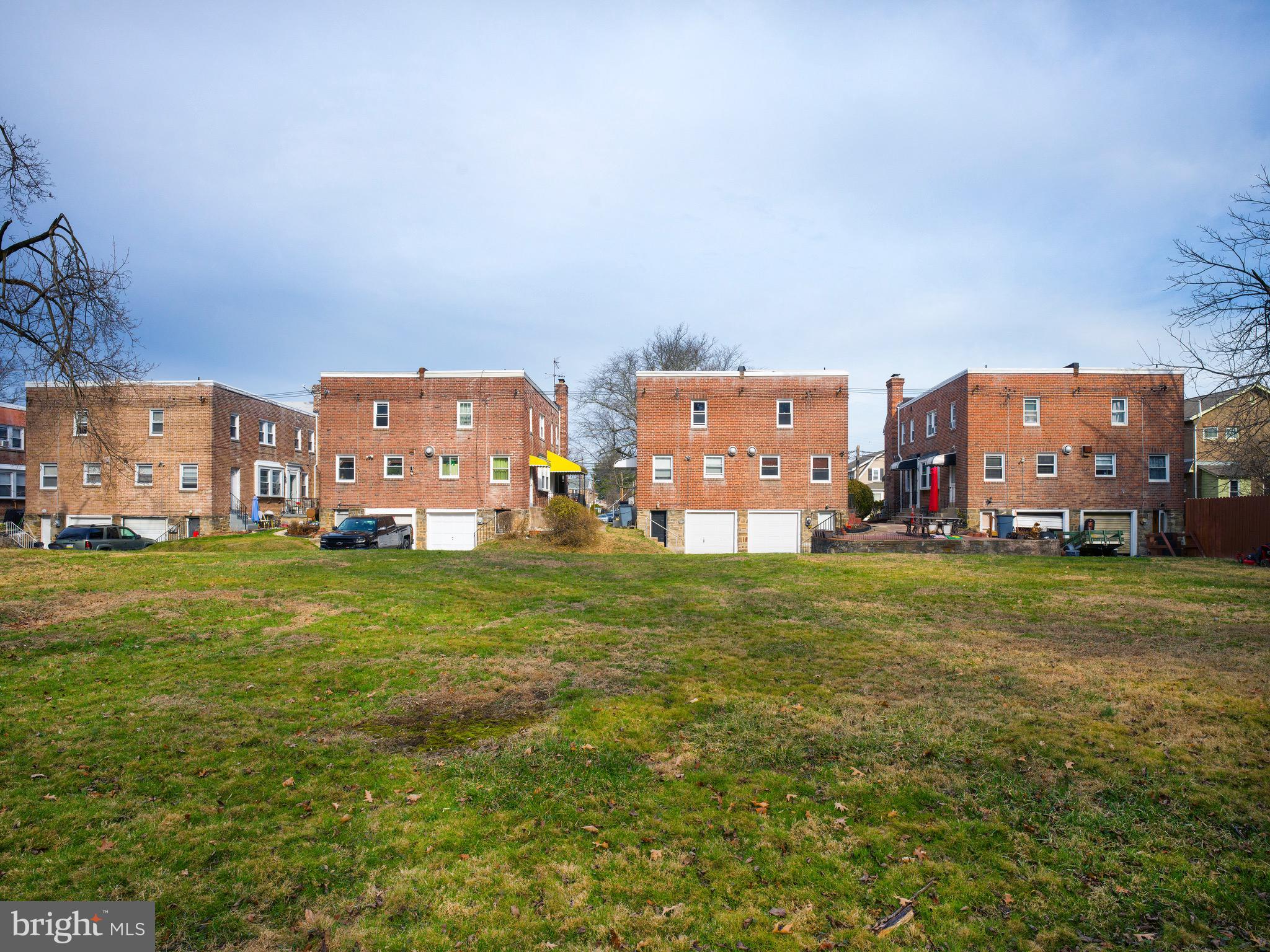 1200 Angora Avenue Lansdowne, PA 19050 - Photo 19 of 20 a view of a big yard with a building and trees in the background