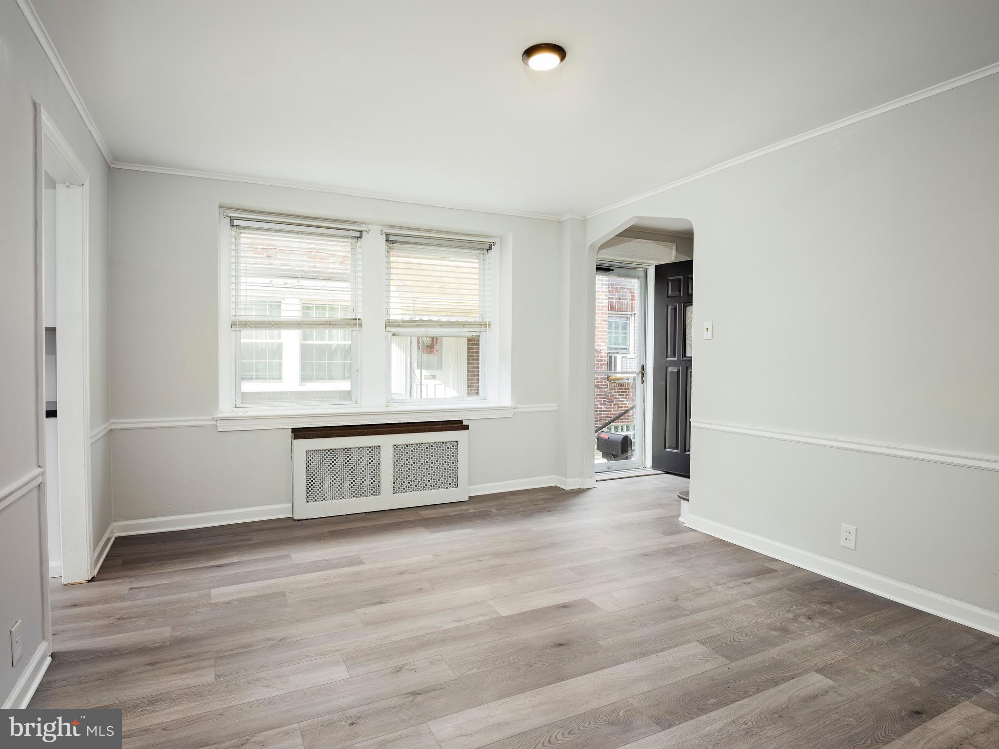 1200 Angora Avenue Lansdowne, PA 19050 - Photo 5 of 20 an empty room with wooden floor and windows