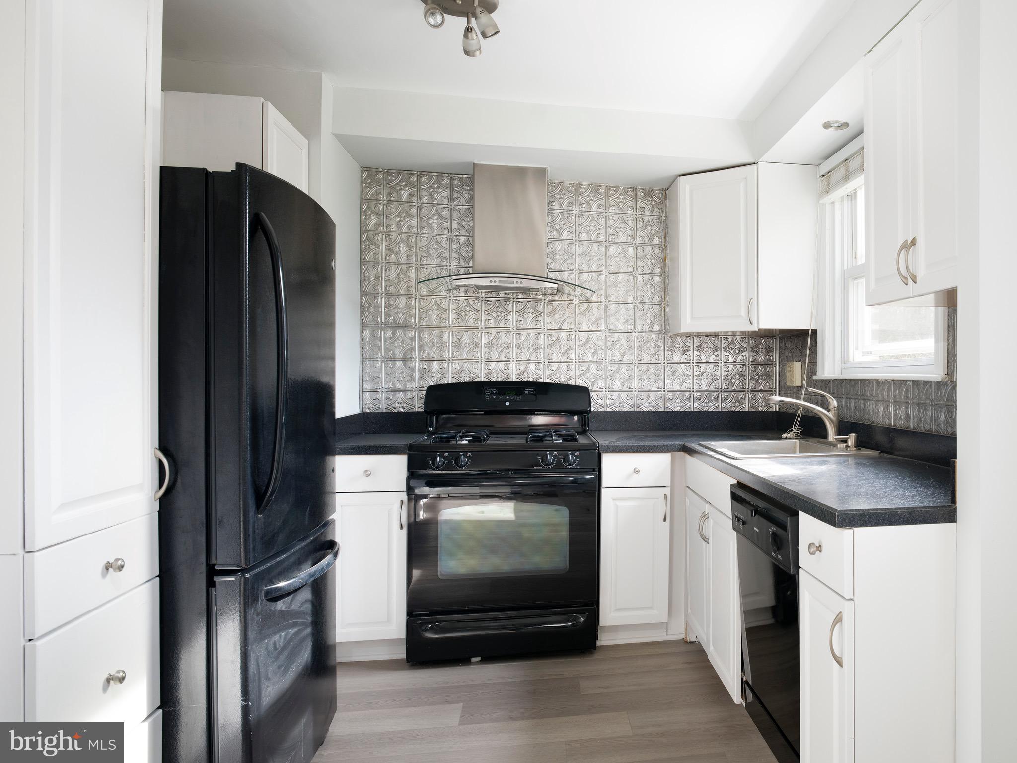 1200 Angora Avenue Lansdowne, PA 19050 - Photo 6 of 20 a kitchen with stainless steel appliances granite countertop a stove a refrigerator and a sink