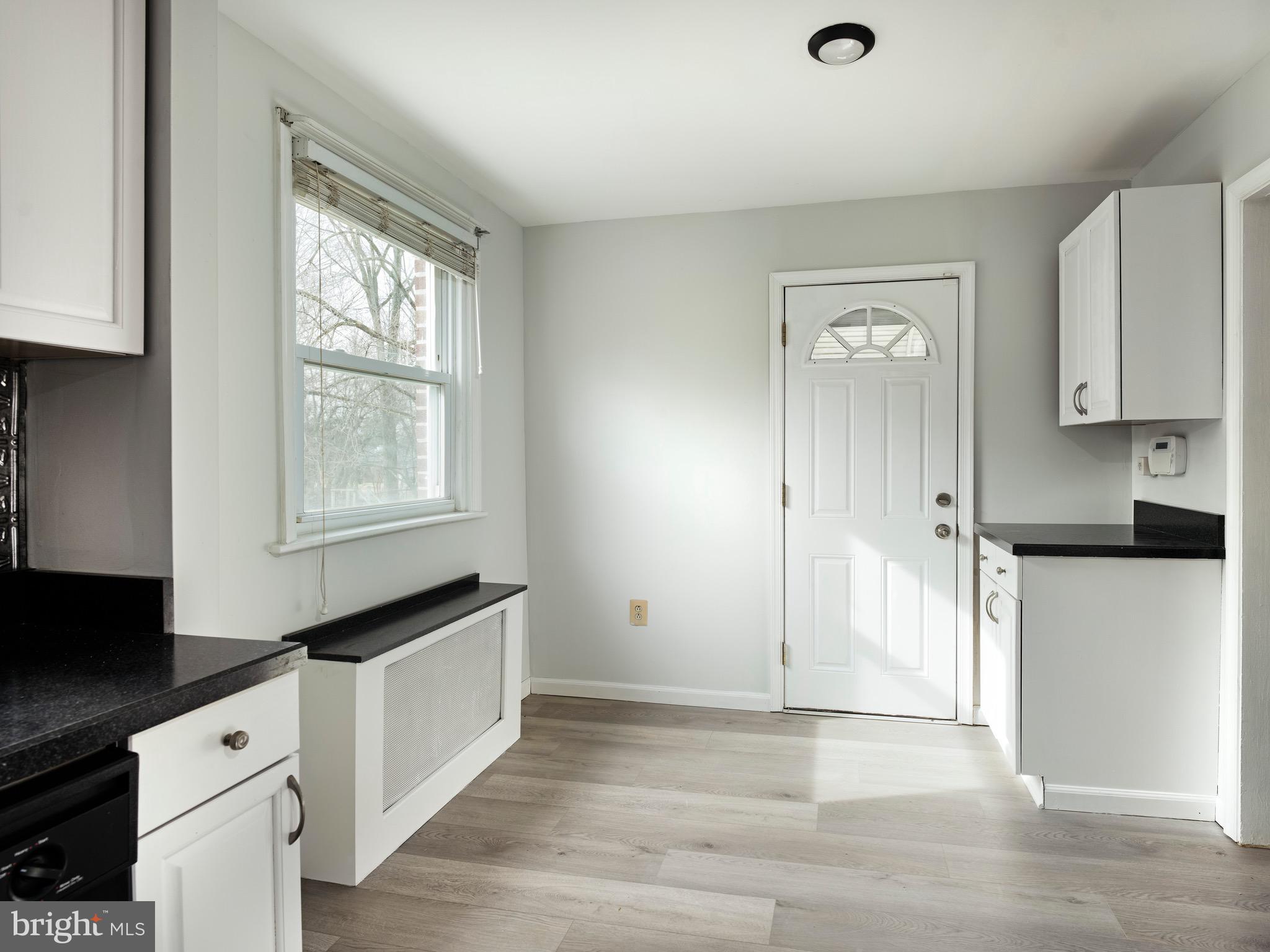 1200 Angora Avenue Lansdowne, PA 19050 - Photo 7 of 20 a kitchen with granite countertop white cabinets and black appliances