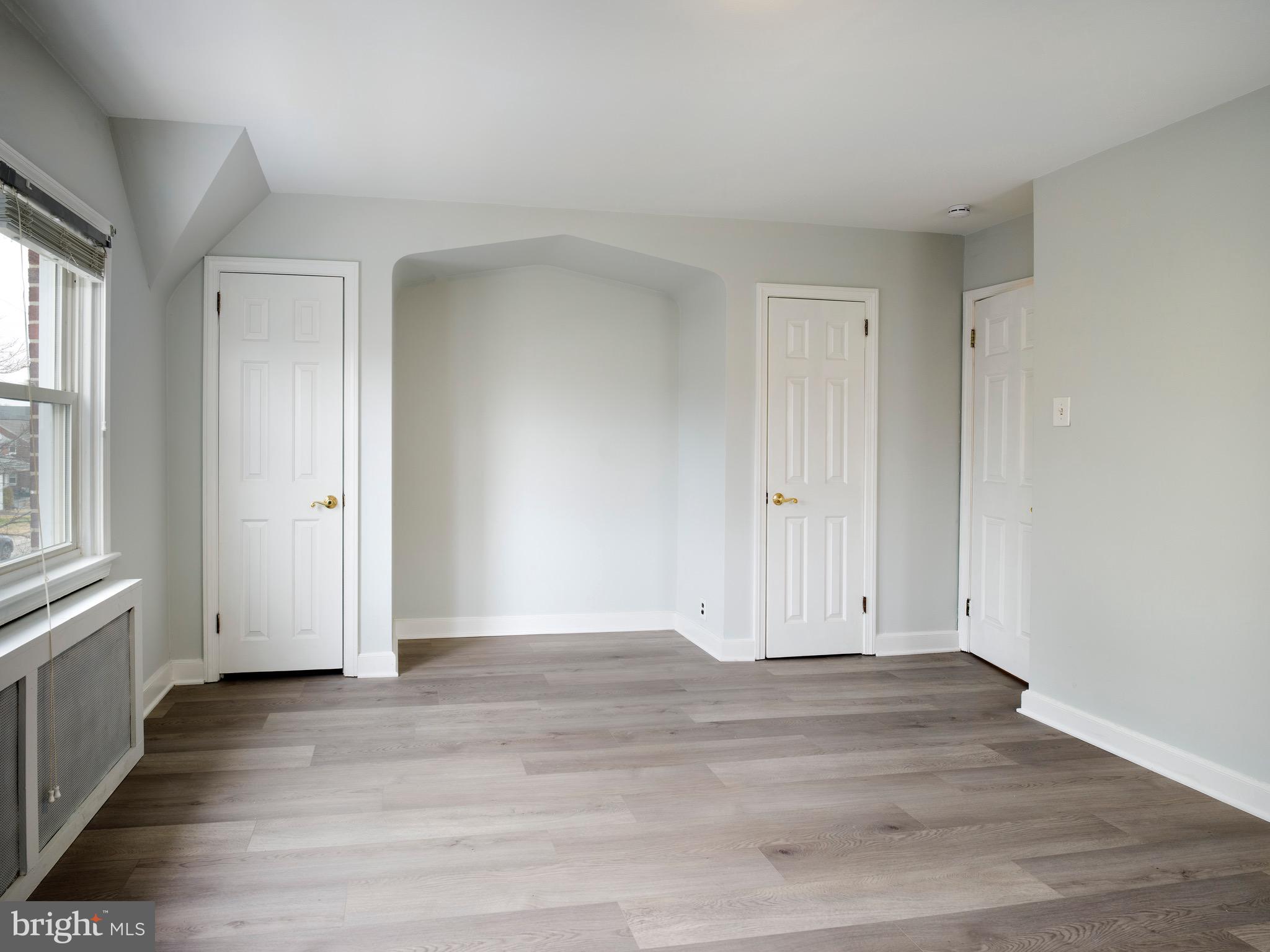 1200 Angora Avenue Lansdowne, PA 19050 - Photo 10 of 20 an empty room with wooden floor and windows