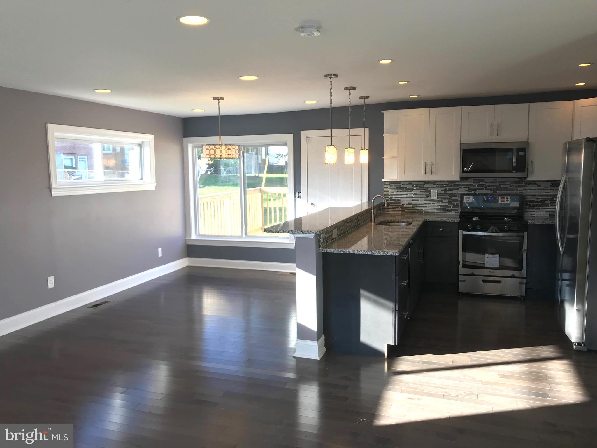 7806 Selgrave Road Baltimore, MD 21244 - Photo 2 of 25 a kitchen with stainless steel appliances granite countertop a stove a sink and a microwave