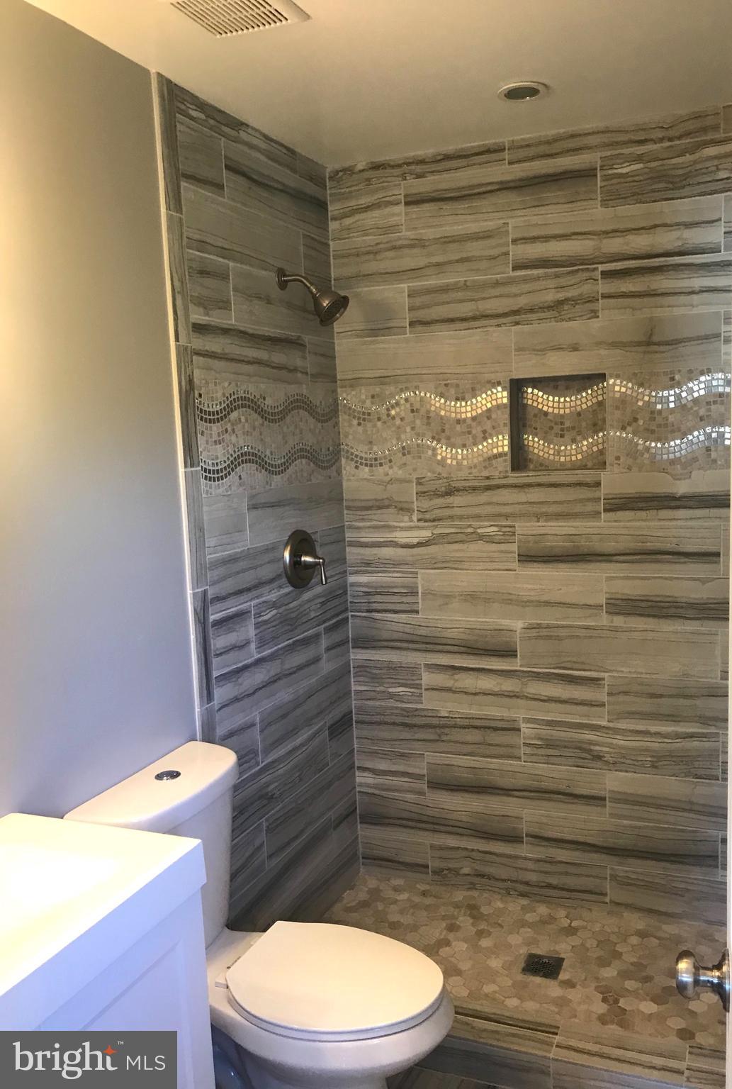 7806 Selgrave Road Baltimore, MD 21244 - Photo 18 of 25 a bathroom with a toilet and a shower