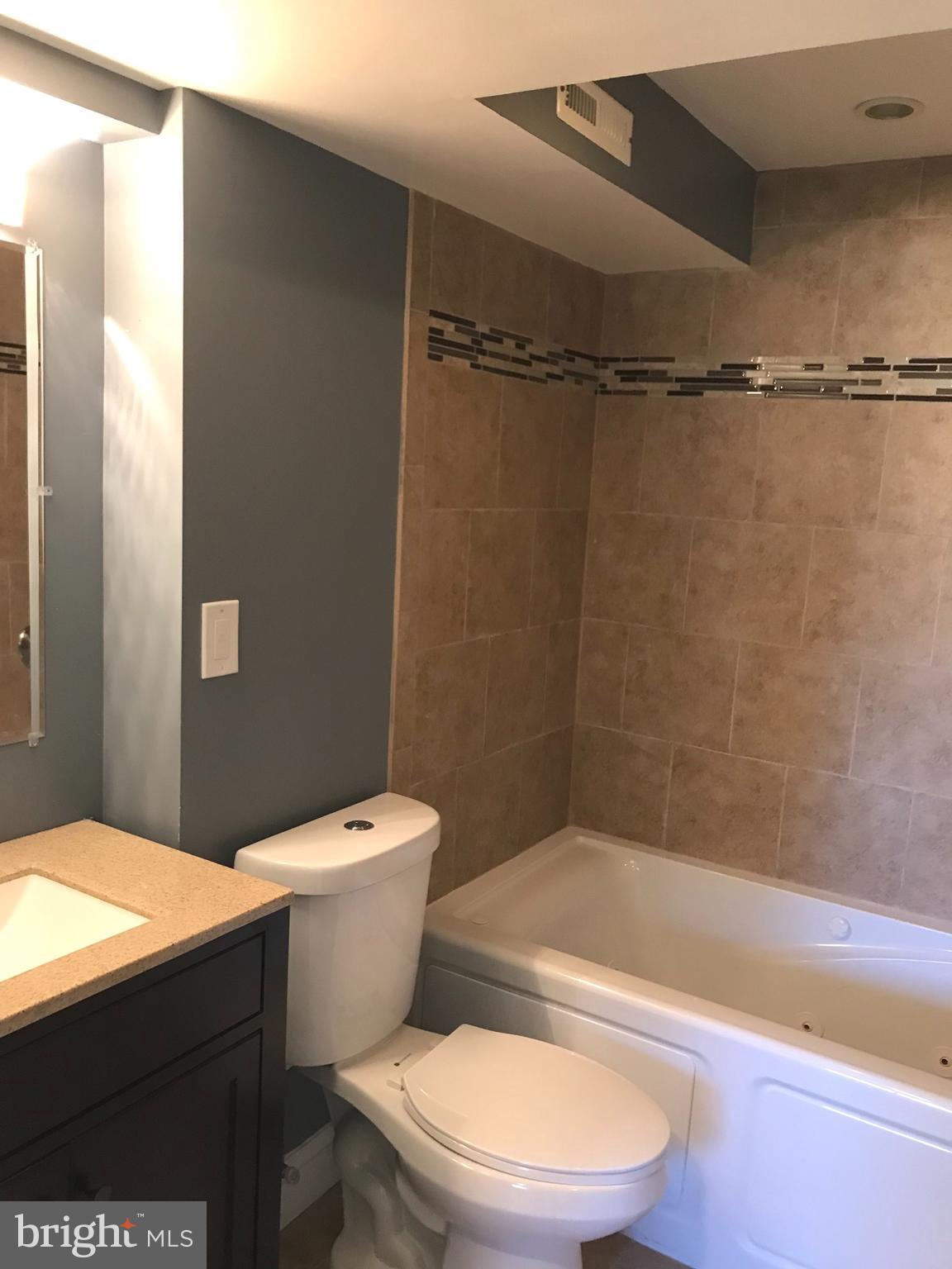 7806 Selgrave Road Baltimore, MD 21244 - Photo 24 of 25 a bathroom with a toilet a sink and bathtub