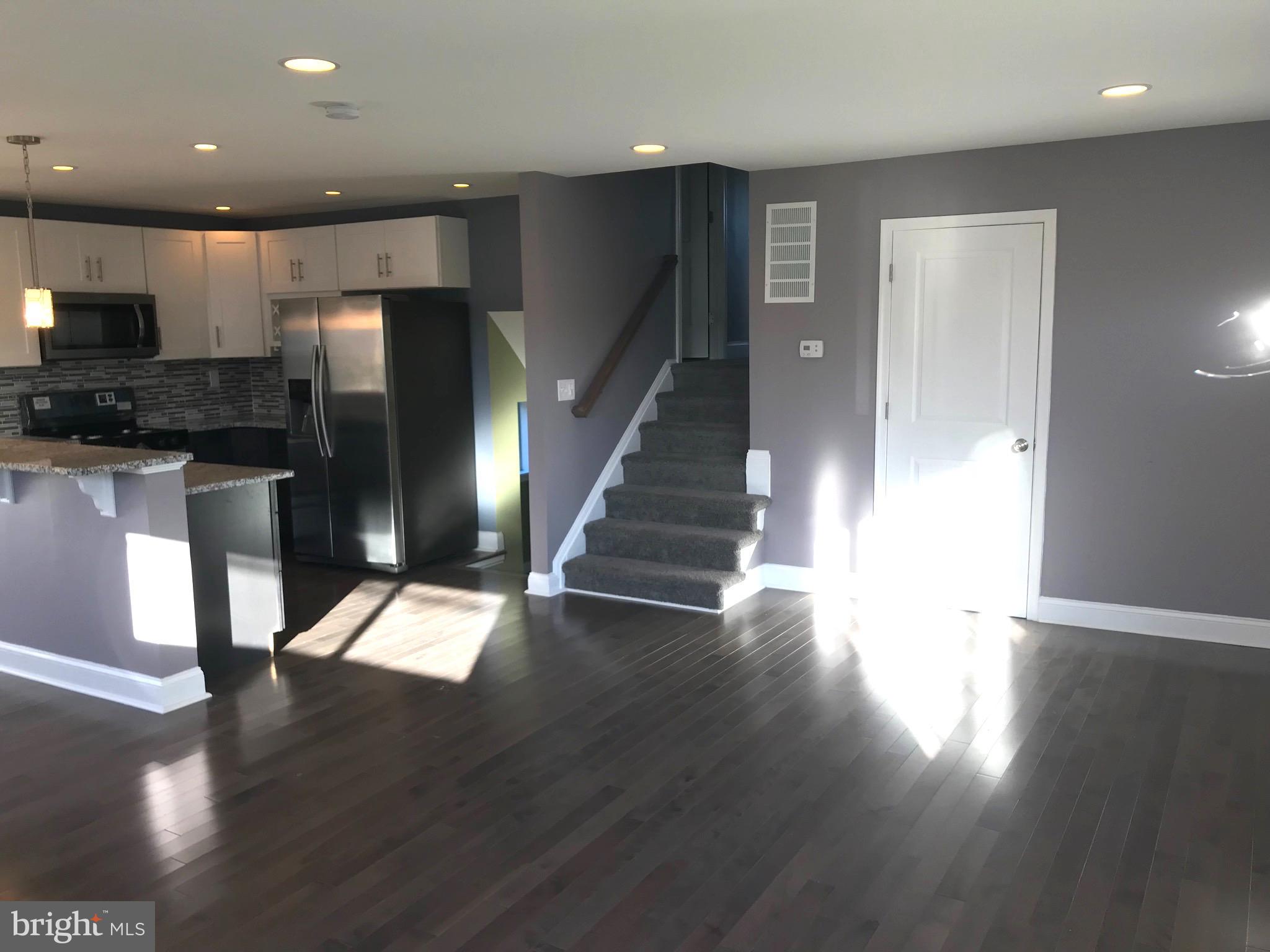 7806 Selgrave Road Baltimore, MD 21244 - Photo 5 of 25 a view of entryway and kitchen with wooden floor