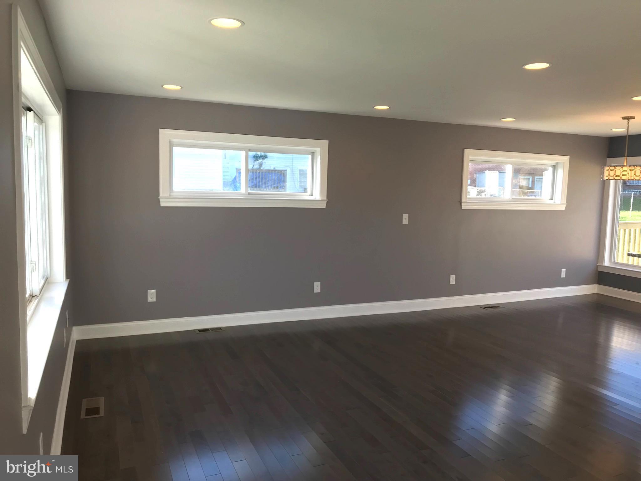 7806 Selgrave Road Baltimore, MD 21244 - Photo 6 of 25 a view of an empty room with wooden floor and a window