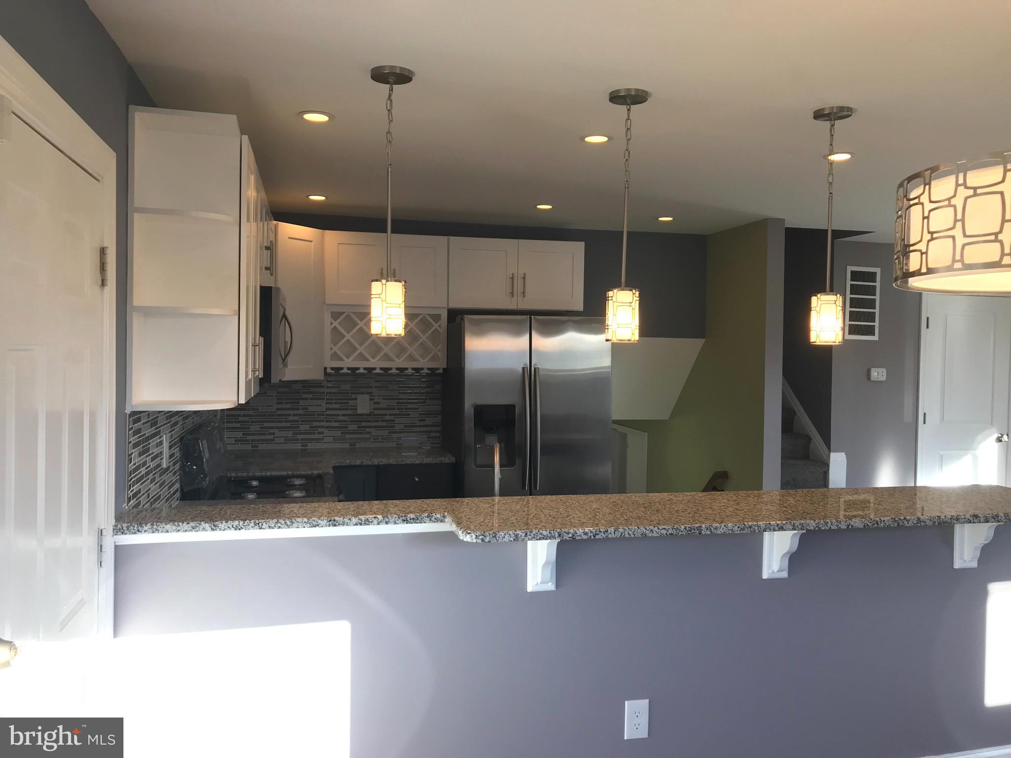 7806 Selgrave Road Baltimore, MD 21244 - Photo 7 of 25 a view of a kitchen with a refrigerator a sink and a counter top