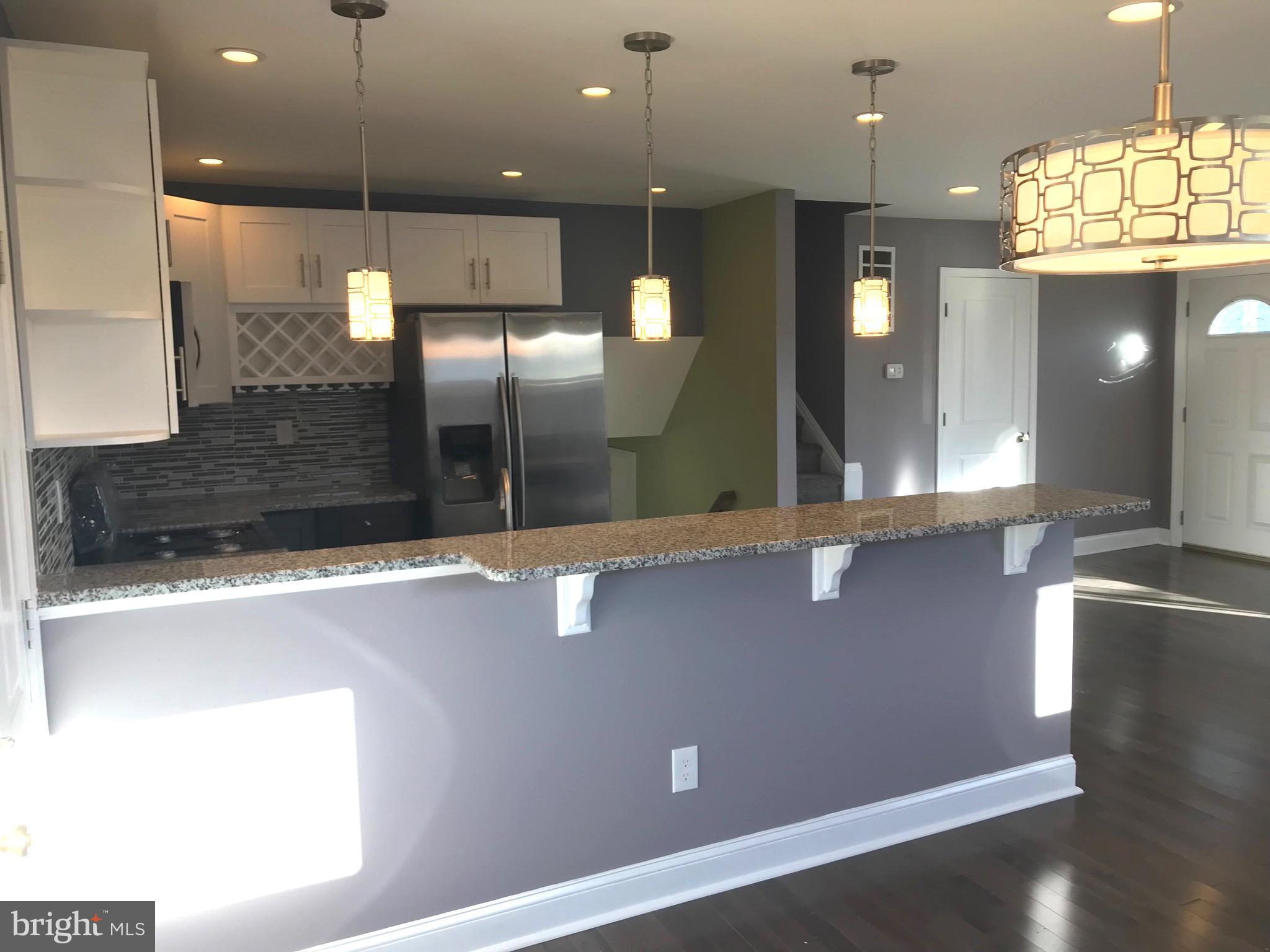 7806 Selgrave Road Baltimore, MD 21244 - Photo 9 of 25 an open kitchen with a refrigerator and fireplace