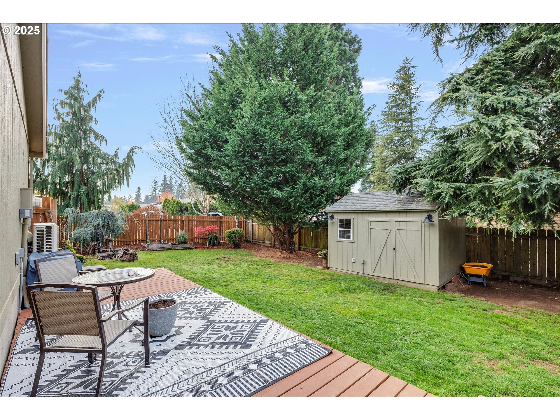 2389 F Street Hubbard, OR 97032 - Photo 23 of 34 a view of a backyard with table and chairs potted plants and a large tree