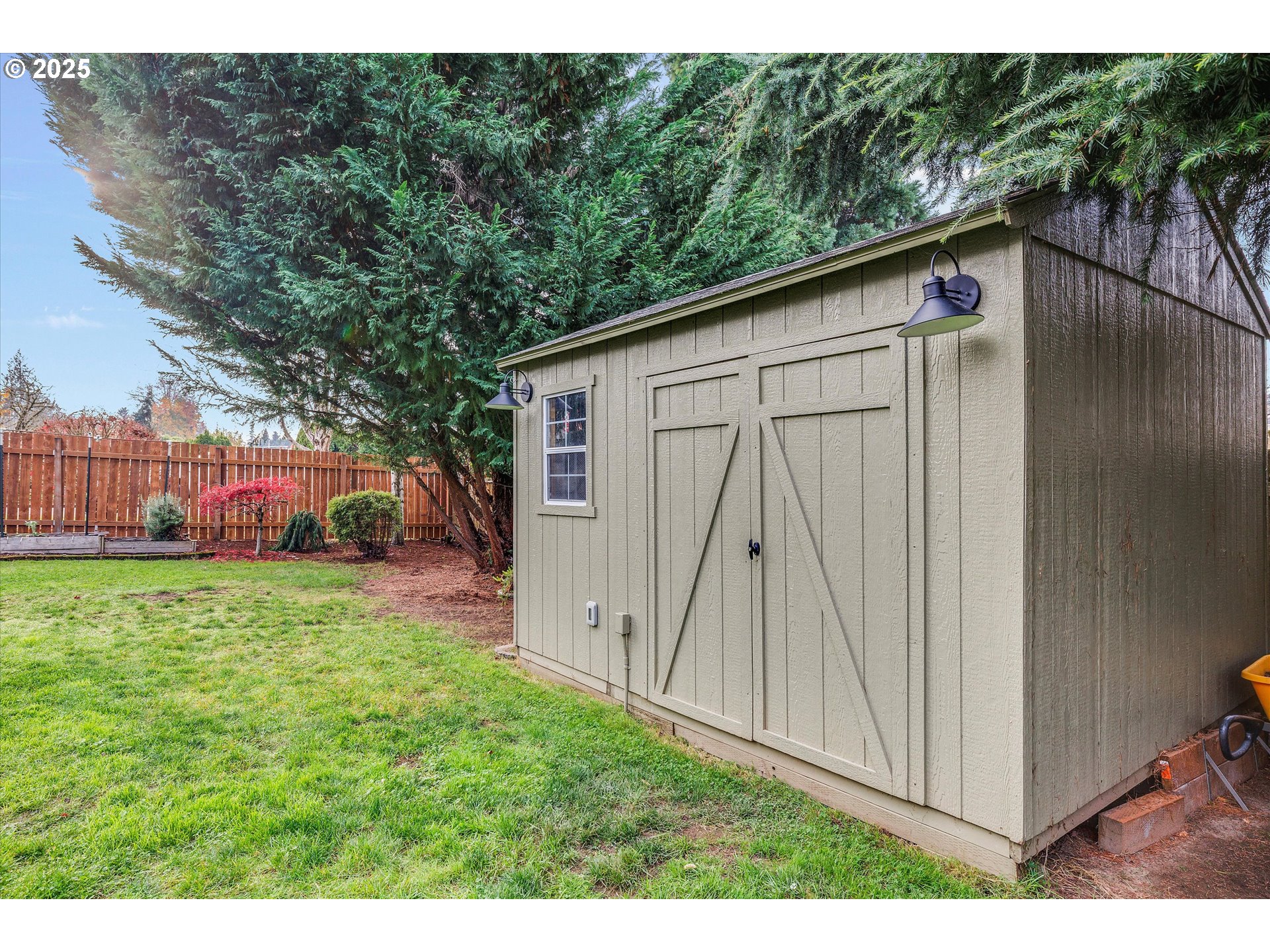 2389 F Street Hubbard, OR 97032 - Photo 25 of 34 a backyard of a house with wooden fence and large trees