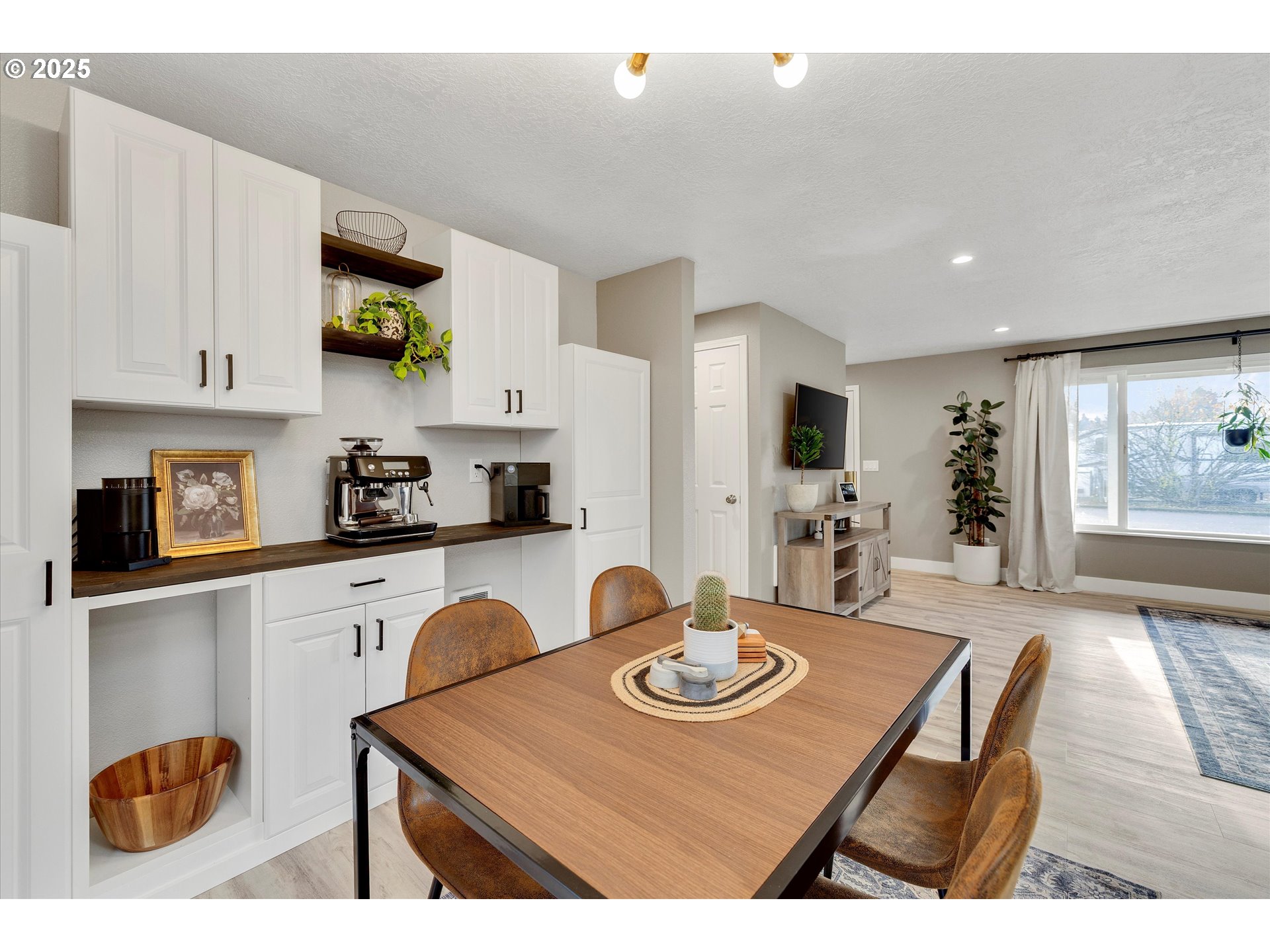 2389 F Street Hubbard, OR 97032 - Photo 9 of 34 a kitchen with stainless steel appliances granite countertop a stove a sink a refrigerator and white cabinets with wooden floor