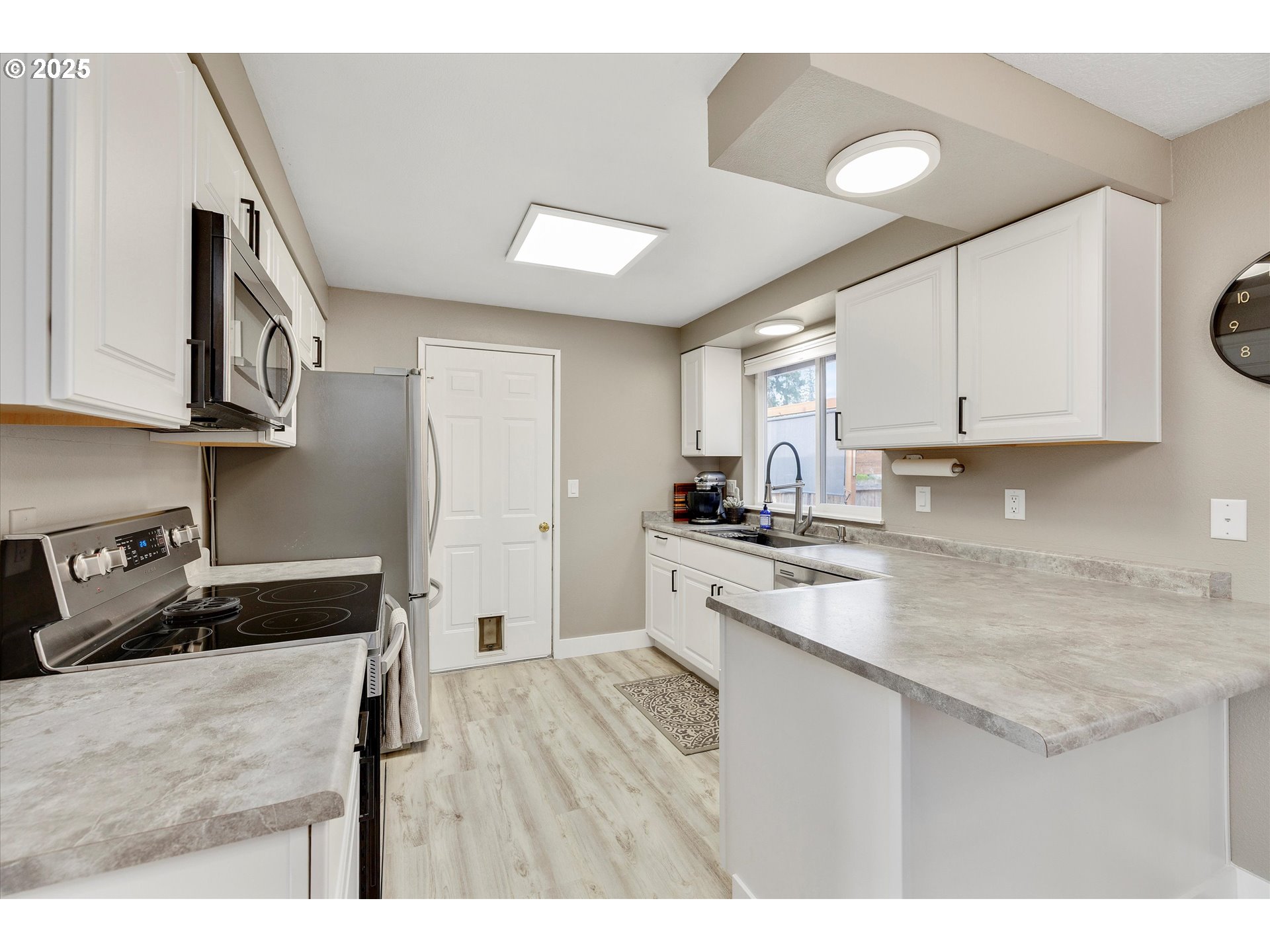 2389 F Street Hubbard, OR 97032 - Photo 10 of 34 a kitchen with a sink a stove and cabinets