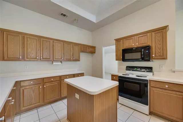 a kitchen with a sink and a stove top oven