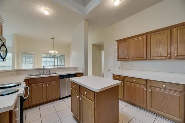 a kitchen that has a sink and a stove in it