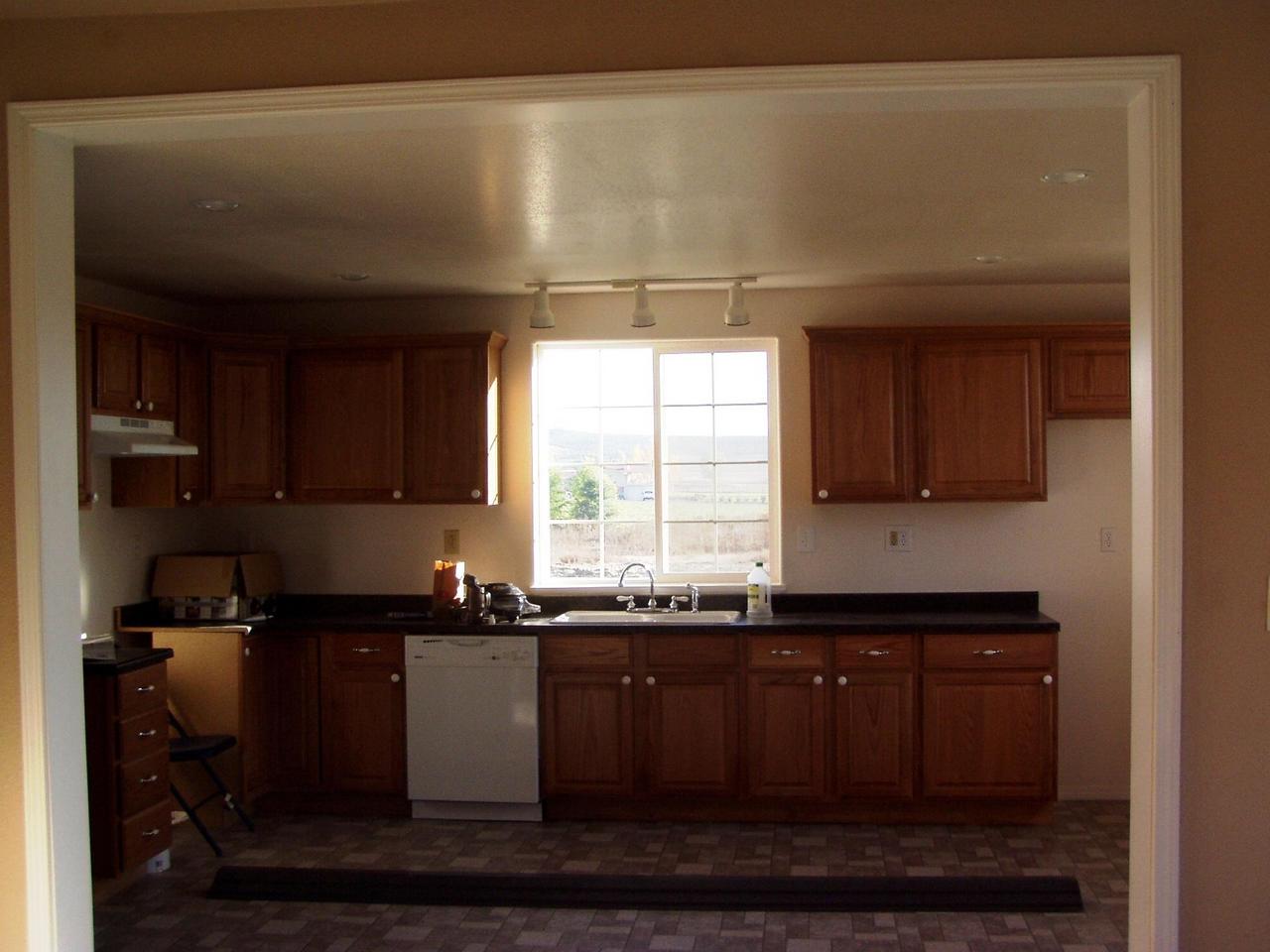 341 Liberty Road Granger, WA 98932 - Photo 16 of 19 a kitchen with granite countertop a sink and cabinets