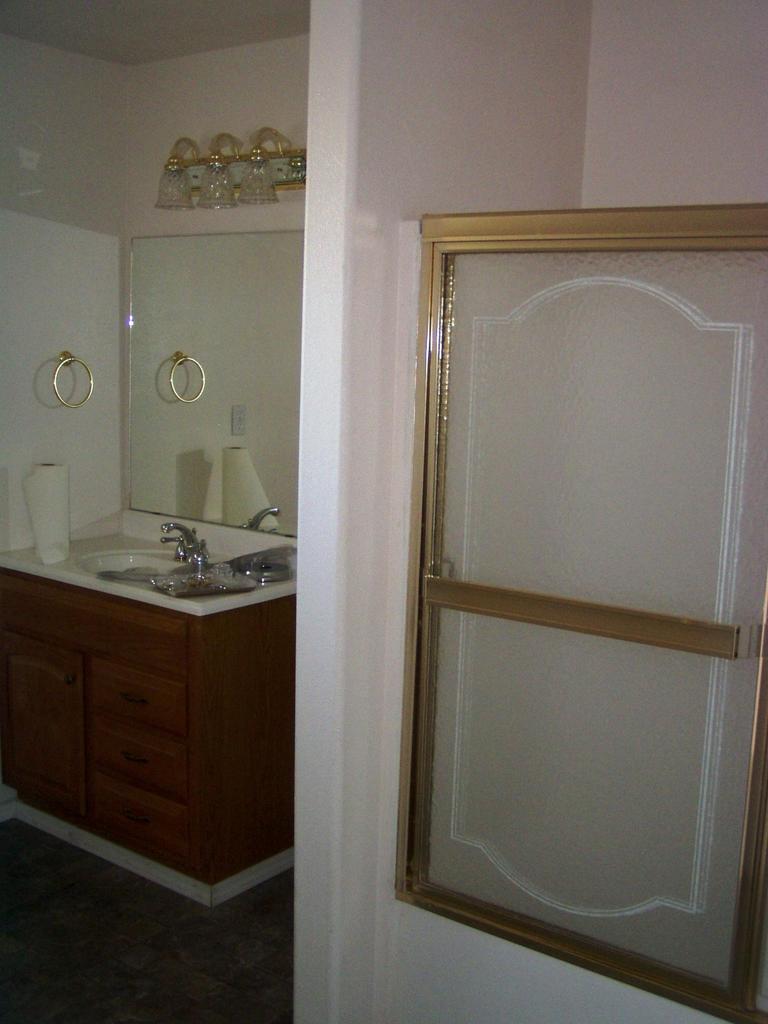 341 Liberty Road Granger, WA 98932 - Photo 4 of 19 a bathroom with a mirror and a sink