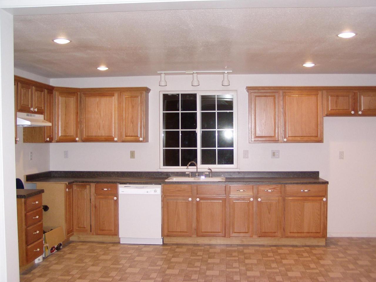341 Liberty Road Granger, WA 98932 - Photo 7 of 19 a kitchen with a sink window and cabinets