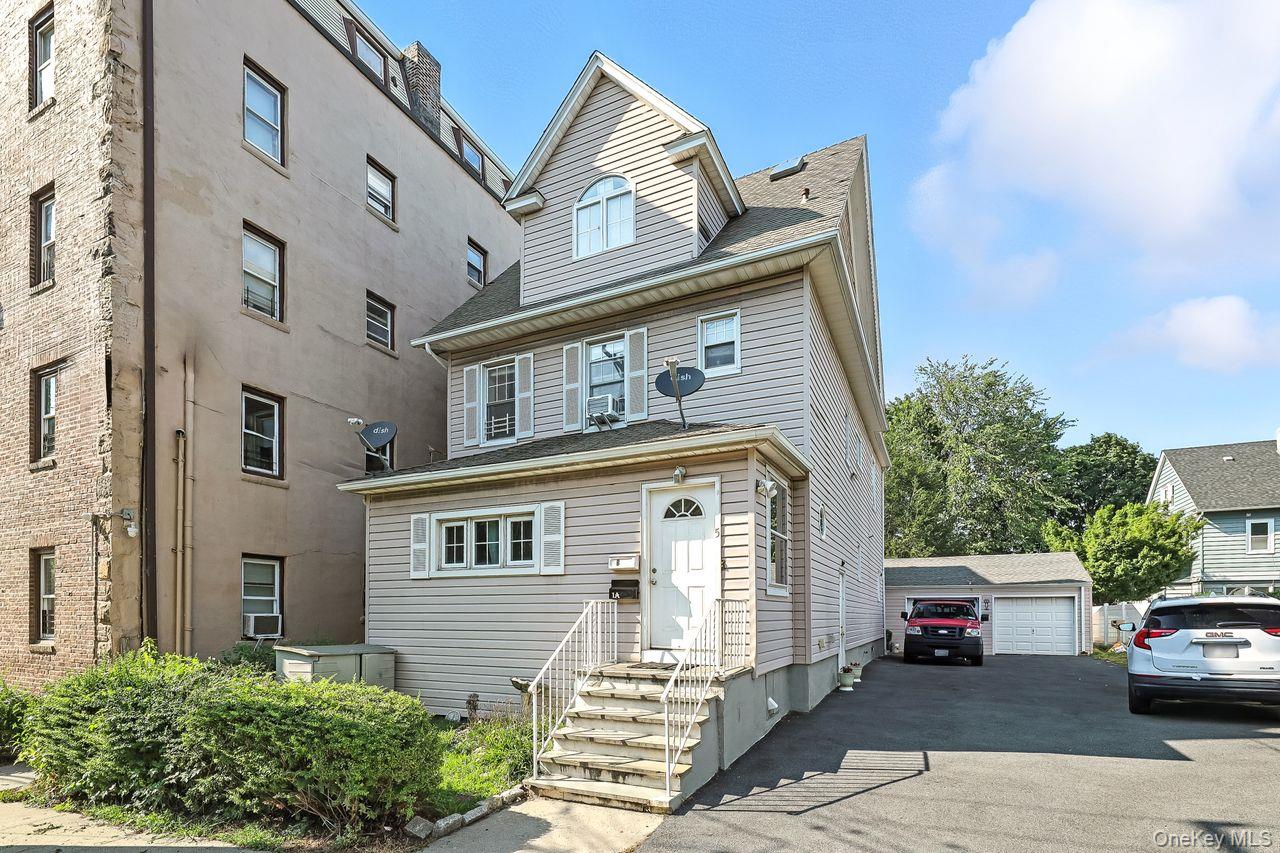 5 Dillon Road Larchmont, NY 10538 - Photo 2 of 36 a front view of a house with a garden