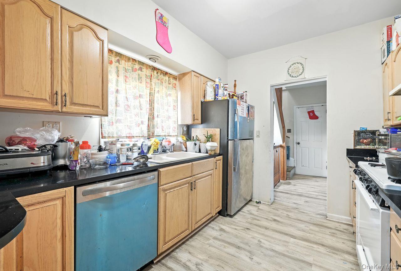 5 Dillon Road Larchmont, NY 10538 - Photo 23 of 36 a kitchen with stainless steel appliances a sink cabinets and a window
