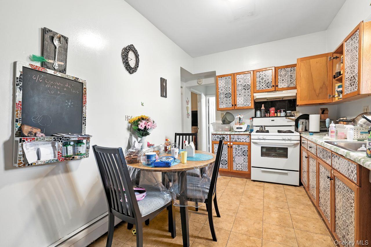 5 Dillon Road Larchmont, NY 10538 - Photo 7 of 36 a kitchen with stainless steel appliances a stove a table and chairs