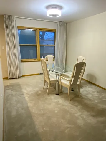 a view of a workspace with furniture and window