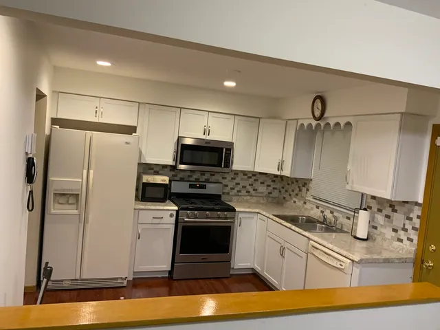 a kitchen with a sink appliances and cabinets