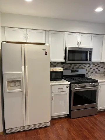 a kitchen with cabinets and steel stainless steel appliances