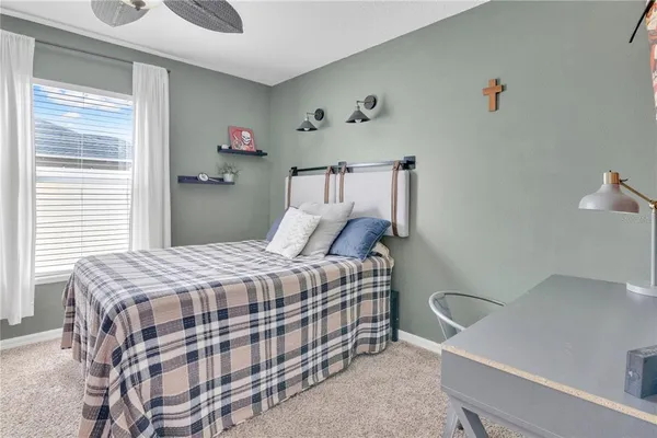 a bedroom with a bed and a chandelier