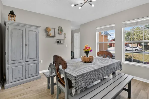 a dining room with furniture and wooden floor