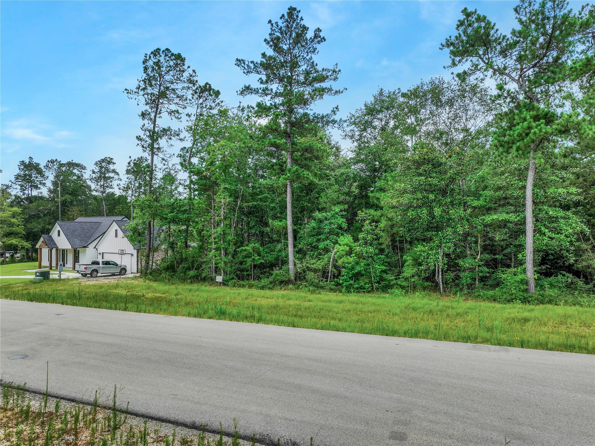 103 Eagle Run Road Willis, TX 77378 - Photo 2 of 35 a view of a house with a big yard and large trees