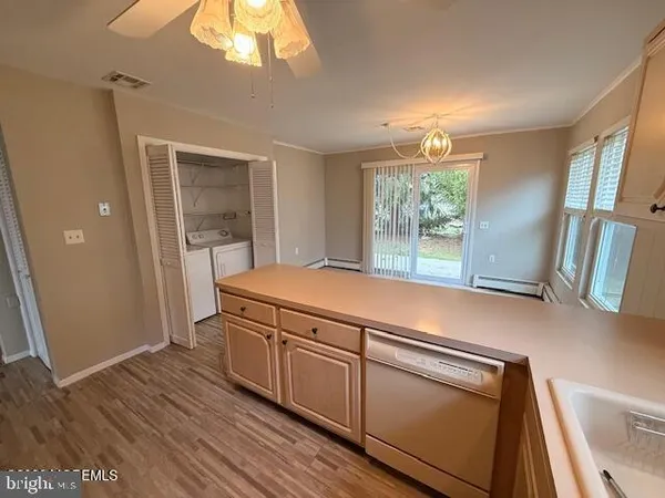 a view of a kitchen with wooden floor and staircase
