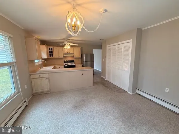 a kitchen with a sink a window and cabinets