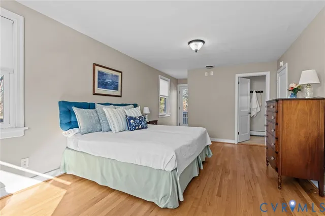 a bed room with two beds and a chair