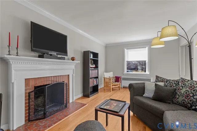 a living room with a fireplace and a flat screen tv