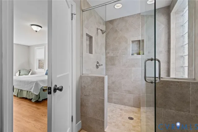 a bathroom with a glass shower door and a sink