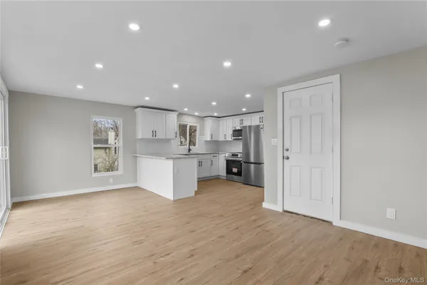 a view of kitchen with wooden cabinet and stainless steel appliances