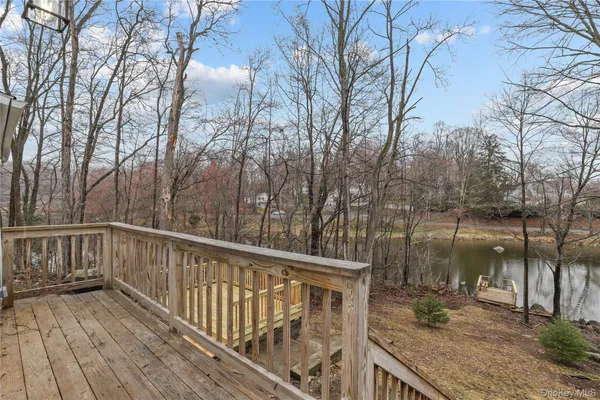 a view of a roof deck with wooden floor and fence