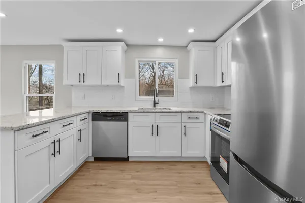 a kitchen with a white cabinets stove and sink