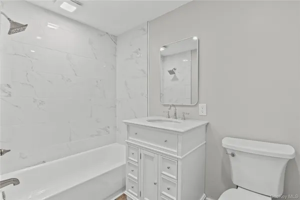a bathroom with a sink a toilet and bathtub