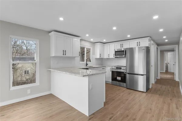 a kitchen with a refrigerator and a stove top oven